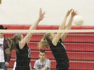 Sara Lindquist and Kris Brackmann jump to block a kill by Mount Si during the KingCo volleyball championship game last Saturday