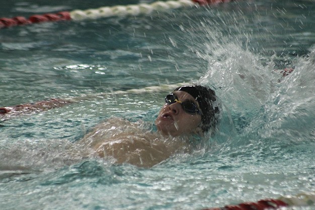 Teddy Larkin swims the 100 backstroke against Lake Washington Thursday