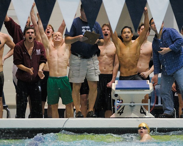 Islanders react to winning the 200-yard freestyle relay during the WIAA 3A swimming and dive state championships at the King County Aquatic Center in Federal Way on Saturday.