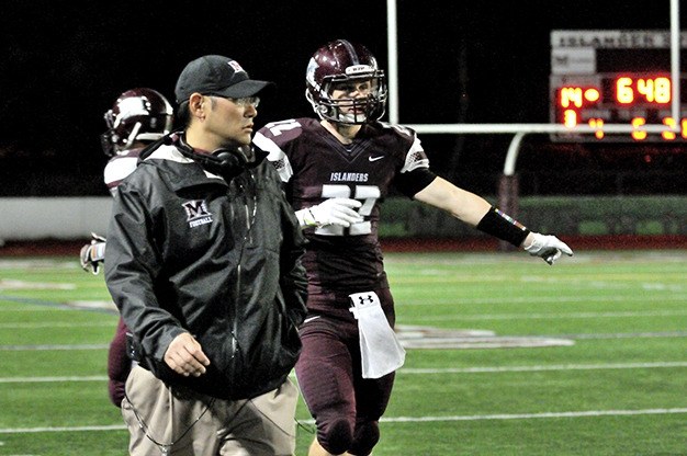 Brett Ogata roams the sidelines with Jack Counihan during Mercer Island’s homecoming game against  Lake Washington Sept. 20.