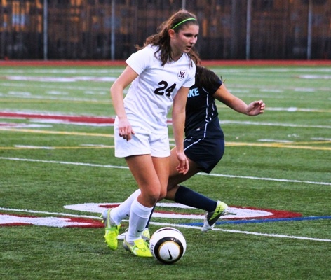 Mercer Island midfielder Katie Rorem dribbles around an Interlake player during the Islanders shoot out win over the Saints on Thursday