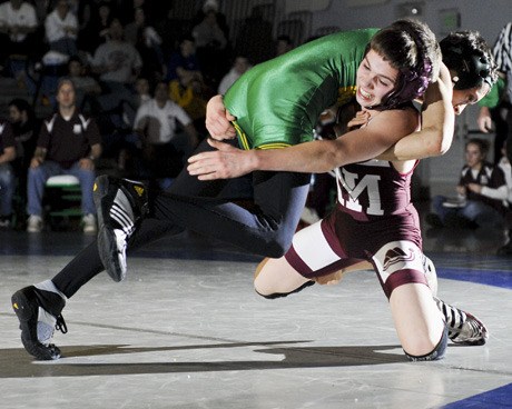 Islander Connor Gullstad competes in the WIAA 3A Region I wrestling final at Liberty High School in Renton on Saturday. Gullstad lost the 103-pound class on points.