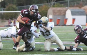 Peter Mahony tries to slip away from Redmond’s defense during the Islanders first home win over the Mustangs on Friday