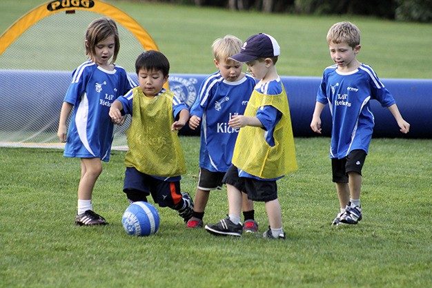 Kids on Keiko Stafford’s Lil’ Kickers team jostle for the ball at Homestead Field on Friday