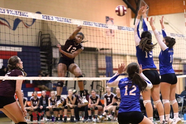Mercer Island's Jemma Yeadon spikes through Seattle Prep's front line during the 3A Sea-King district tournament Saturday