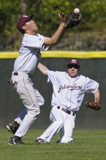 Islanders 2B Kirby Ingram makes a running catch as RF George Jiranek slides to avoid contact with is teammate against Sammamish during Kingco 3A baseball playoffs at Bannerwood Park in Bellevue on Thursday