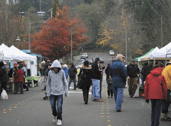 Shoppers at the Farmer's Market on Sunday got a chilly surprise as snow began to fall during the harvest market.
