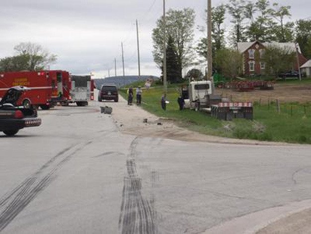 The truck involved in the collision that killed Islander Isabel Gallagher in northern Ontario sits in the ditch at right.