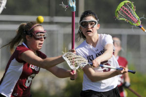 Islander Victoria Bachman scores a goal against Holy Names.