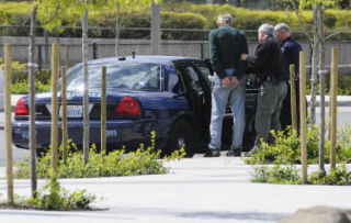 Mercer Island police officers arrest a man at the Mercer Island Park and Ride on April 30.
