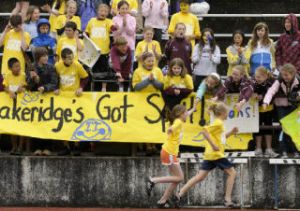 Lakeridge athletes are congratulated by friends and teammates as they sprint back to the stands after racing in the 38th annual All-Island Track Meet.