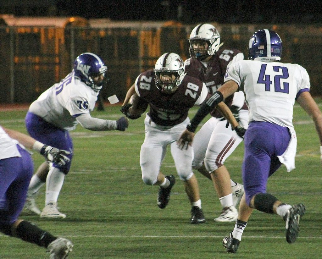 Mercer Island&rsquo;s Jordano Mark (28) rushes against Lake Washington Oct. 21 at Islander Stadium (Joe Livarchik/staff photo).