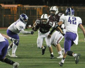 Mercer Island&rsquo;s Jordano Mark (28) rushes against Lake Washington Oct. 21 at Islander Stadium (Joe Livarchik/staff photo).