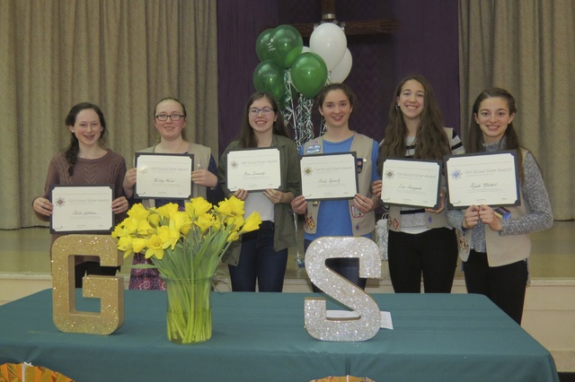 Mercer Island Girl Scouts hold up their awards during an annual banquet at the Mercer Island Presbyterian Church on Feb. 28. From left to right: Stella Goffman