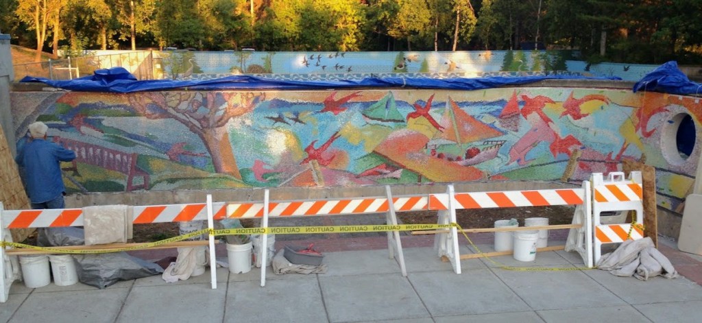 Artist José Orantes grouts the mosaic mural at the Luther Burbank Park playground. His paintings will be on display in the Mercer Gallery from Sept. 12 to Oct. 28