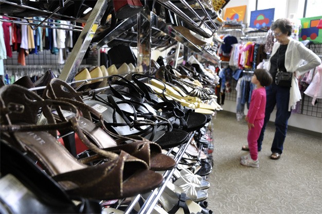 Customers at the Island YFS thrift store look over shoes on the second floor of the store last week. City staff and volunteers have worked to update the shop