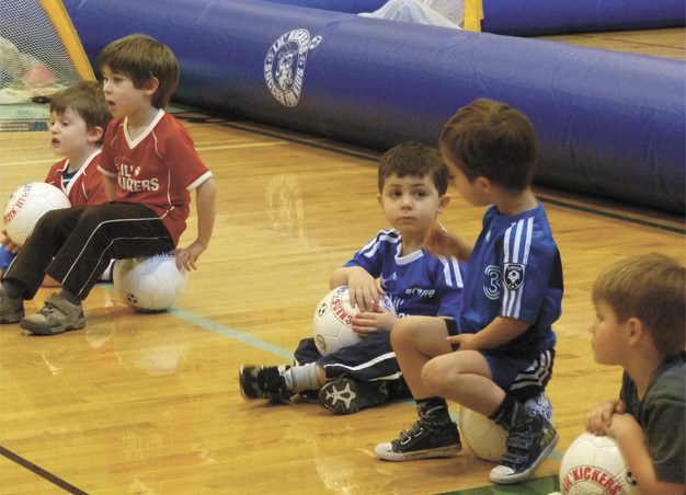A pair of budding soccer stars share strategy at an Arena Sports’ Lil Kicker’s class at the Community Center at Mercer View last Saturday morning. Four classes of up to 10 tiny athletes run simultaneously.