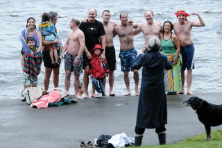 Islanders and friends pose for a group photo after braving a cold wind to welcome the New Year by plunging into Lake Washington at Clarke Beach Park on the South end of Mercer Island