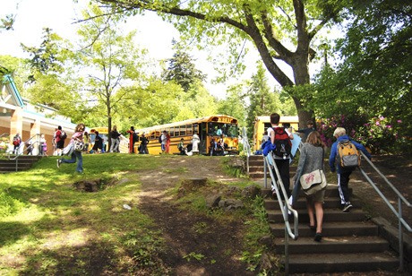 Students walk to their buses after school is let out at West Mercer Elementary on May 24. In celebration of Memorial Day