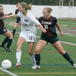 Mercer Island forward Nicole Mandt (22) fights off Mt. Spokane defender Emily Hahn during the Islanders&rsquo; winner-to-state matchup against the Wildcats Saturday at Islander Stadium. Mercer Island won 2-0. Joe Livarchik/staff photo.