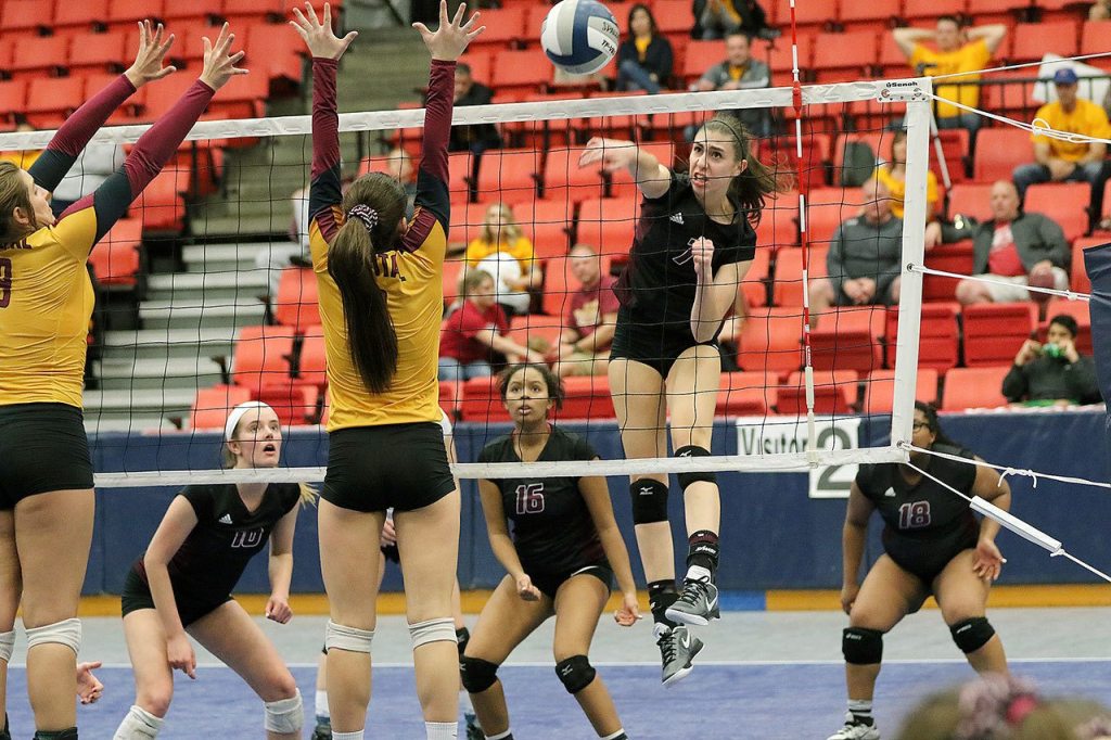 Kelly Behrbaum follows through on a spike against Capital. Photo courtesy of Willy Paine.