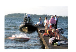 A classic wooden boat sinks just meters away from a residential dock on the north end of Mercer Island. All four passengers made it safely to land.