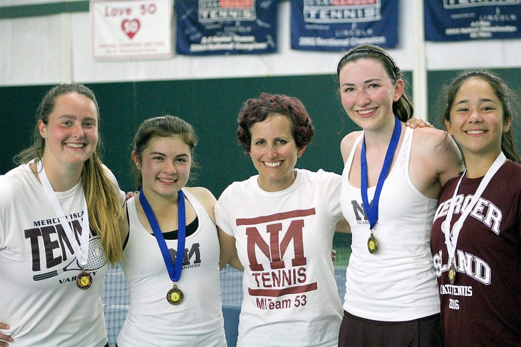 From left, Fiona Brasfield, Sammy Sweet, Mercer Island girls tennis coach Carol Gullstad, Caroline Hamilton and Chloe Gage show off the medals won by the Islander doubles teams. File photo.