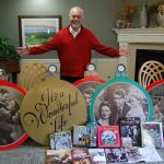 Covenant Shores Chaplain Greg Asimakoupoulos poses with some of his &ldquo;It&rsquo;s a Wonderful Life&rdquo; memorabilia. Asimakoupoulos is speaking at the annual festival celebrating the movie in Seneca Falls, New York, this weekend. Katie Metzger/staff photo