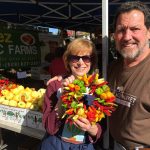 Retiring market manager Patty Spahr poses with her husband at the Mercer Island Farmers Market. Contributed photo