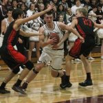 Mercer Island&rsquo;s Griffin Emanuels fights through Sammamish defenders Max Donaldson (left) and Kenneth Rasmussen (23) Friday at Mercer Island High School. The Islanders beat the Totems 66-45. Joe Livarchik/staff photo.