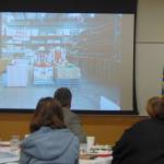 Costco CFO Richard Galanti shows the Mercer Island Chamber a photo of an old Costco layout, with the deli products next to the tires, at the Dec. 1 meeting. Katie Metzger/staff photo