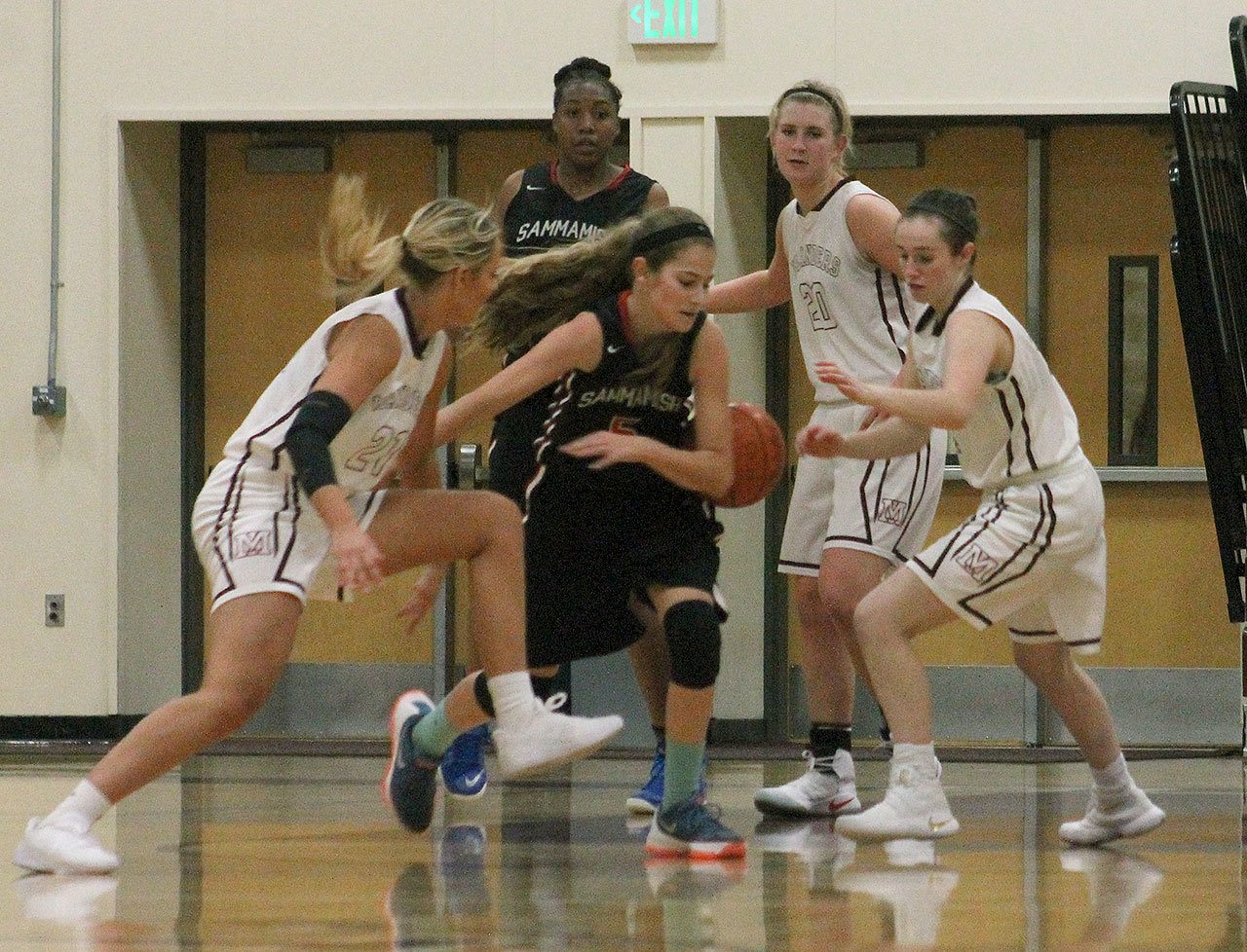 Mercer Island&rsquo;s Macy Mounger, far left, and Claire Mansfield, far right, swarm Sammamish guard Katelyn Nagel during the Islanders&rsquo; home opener against the Totems Friday at Mercer Island High School. Mercer Island beat Sammamish 69-33. Joe Livarchik/staff photo.