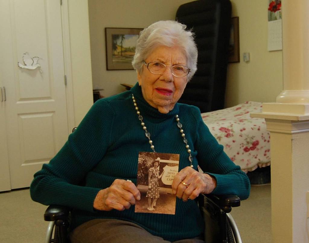 Covenant Shores resident Lois Dusenbery holds a photo of herself taken at Hickam Field, the Air Force base that borders Pearl Harbor. Dusenberry witnessed the attack on Pearl Harbor 75 years ago. Katie Metzger/staff photo