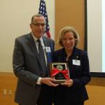 Mercer Island Chamber of Commerce President Ralph Swanson presents Roanoke owner Dorothy Reeck with the 2016 Business of the Year award at the Dec. 1 luncheon. Katie Metzger/staff photo