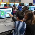 TOSA Kara Millsap helps a second-grader at West Mercer Elementary complete a &ldquo;progression puzzle&rdquo; as part of the national Hour of Code event. Katie Metzger/staff photos