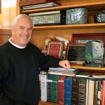 Paul Jackson with his trophy shelf at his Mercer Island home. In March, Jackson will be inducted into the National Wrestling Hall of Fame for lifetime service to the sport. Joe Livarchik/staff photo.