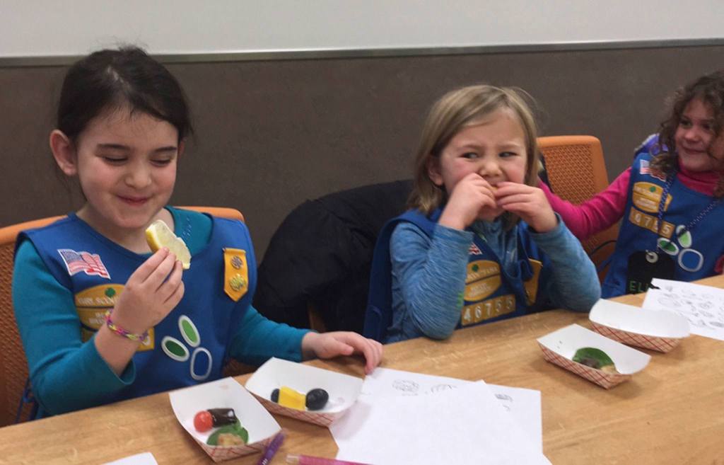 Ori Talby and Juliette Lowe participate in their Daisy troop&rsquo;s &ldquo;eat the rainbow&rdquo; challenge on Dec. 5 at New Seasons. Photo courtesy of Ashley Sternberg