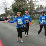 Runners get high-fives as they cross the finish line and complete the 5K at the Mercer Island Rotary Half on March 20. Katie Metzger/staff photo