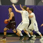 Mercer Island&rsquo;s Griffin Emanuels looks to pass against Lake Washington defenders Griffin Barker (11) and Sam Linsky Friday at Lake Washington High School. The Kangs rallied to beat the Islanders 61-60 (Joe Livarchik/staff photo).