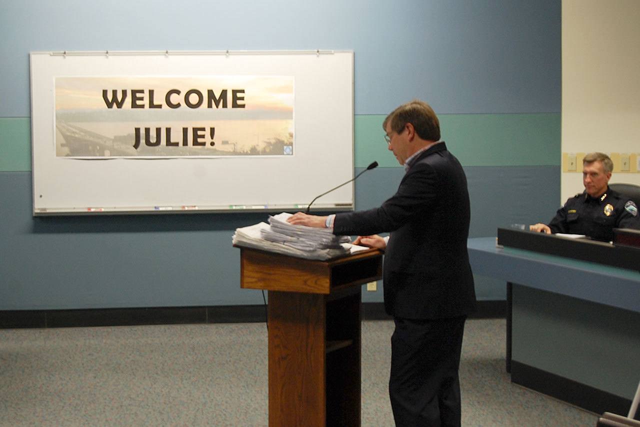 CCMIP Co-chair Peter Struck presents the stack of signed petitions at the Jan. 3 City Council meeting. Katie Metzger/staff photo