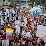 Marchers gather in Judkins Park to listen to speeches before marching to Seattle Center. Allison DeAngelis/Bellevue Reporter