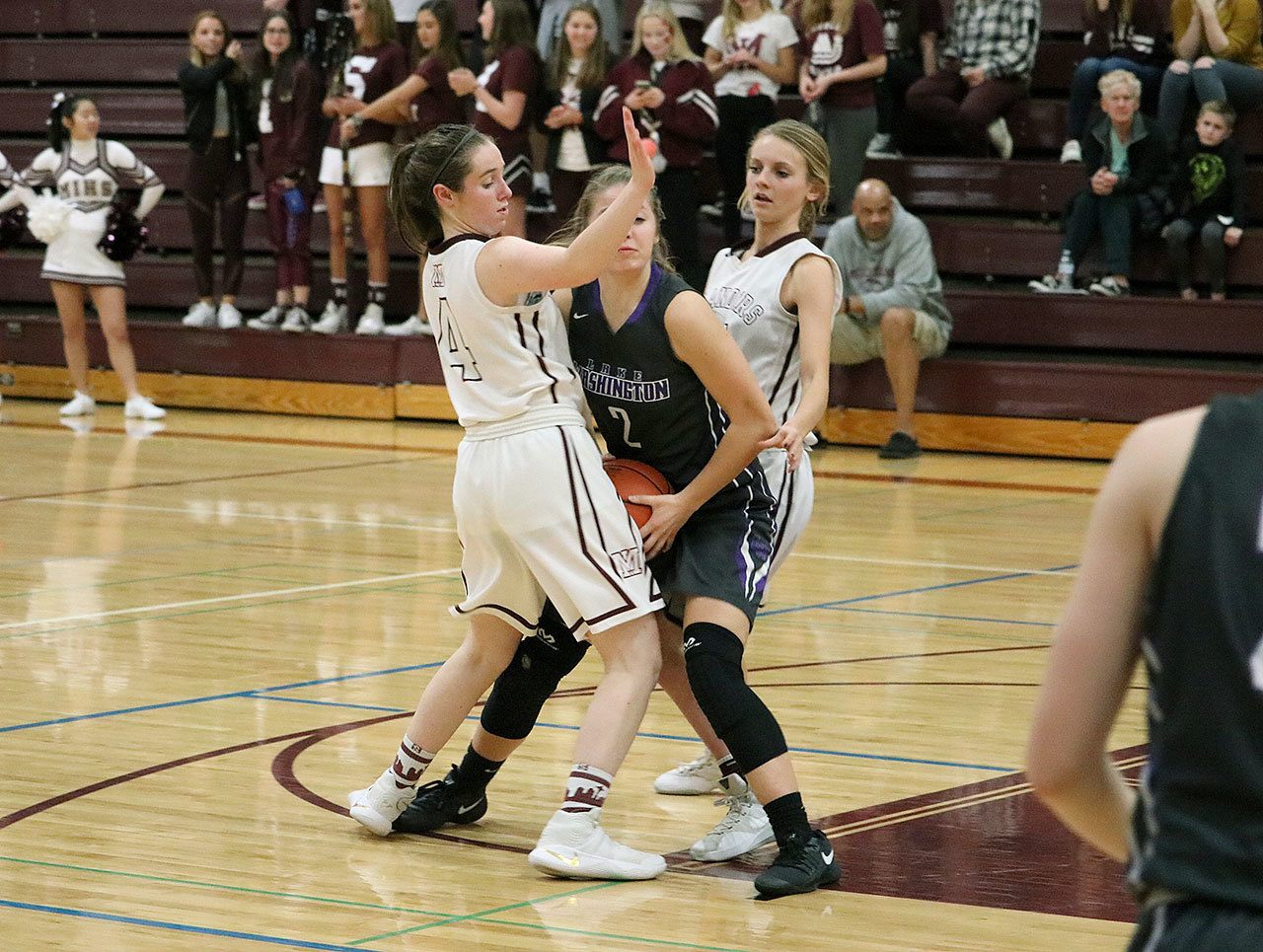 Mercer Island&rsquo;s Claire Mansfield (4) and Jackie Stenberg converge defensively on Lake Washington&rsquo;s Lindsay Allan Tuesday at Mercer Island High School. The Islanders beat the Kangs 69-24 (Joe Livarchik/staff photo).