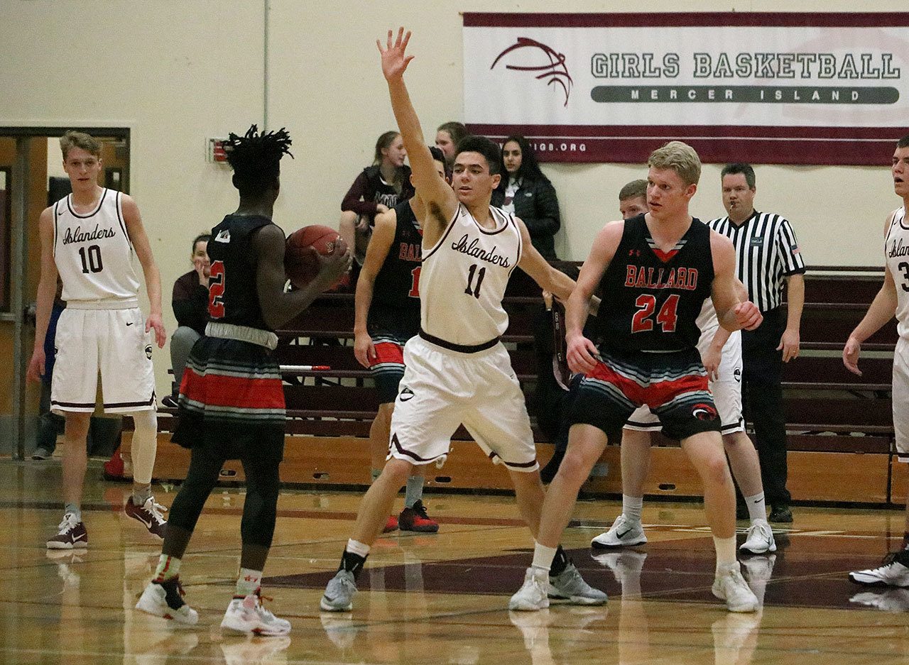 Mercer Island&rsquo;s Ethan Eason (11) defends Ballard&rsquo;s Fresh Ausar (2) Saturday night at Mercer Island High School. The Beavers beat the Islanders 41-37 to end Mercer Island&rsquo;s season (Joe Livarchik/staff photo).