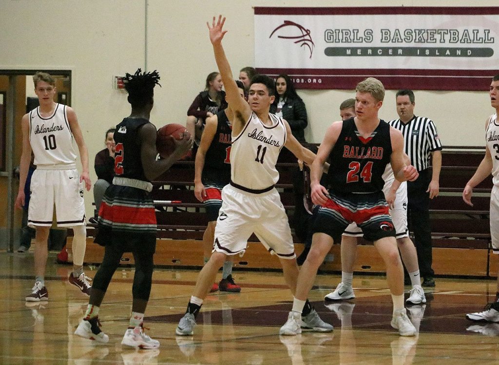 Mercer Island&rsquo;s Ethan Eason (11) defends Ballard&rsquo;s Fresh Ausar (2) Saturday night at Mercer Island High School. The Beavers beat the Islanders 41-37 to end Mercer Island&rsquo;s season (Joe Livarchik/staff photo).