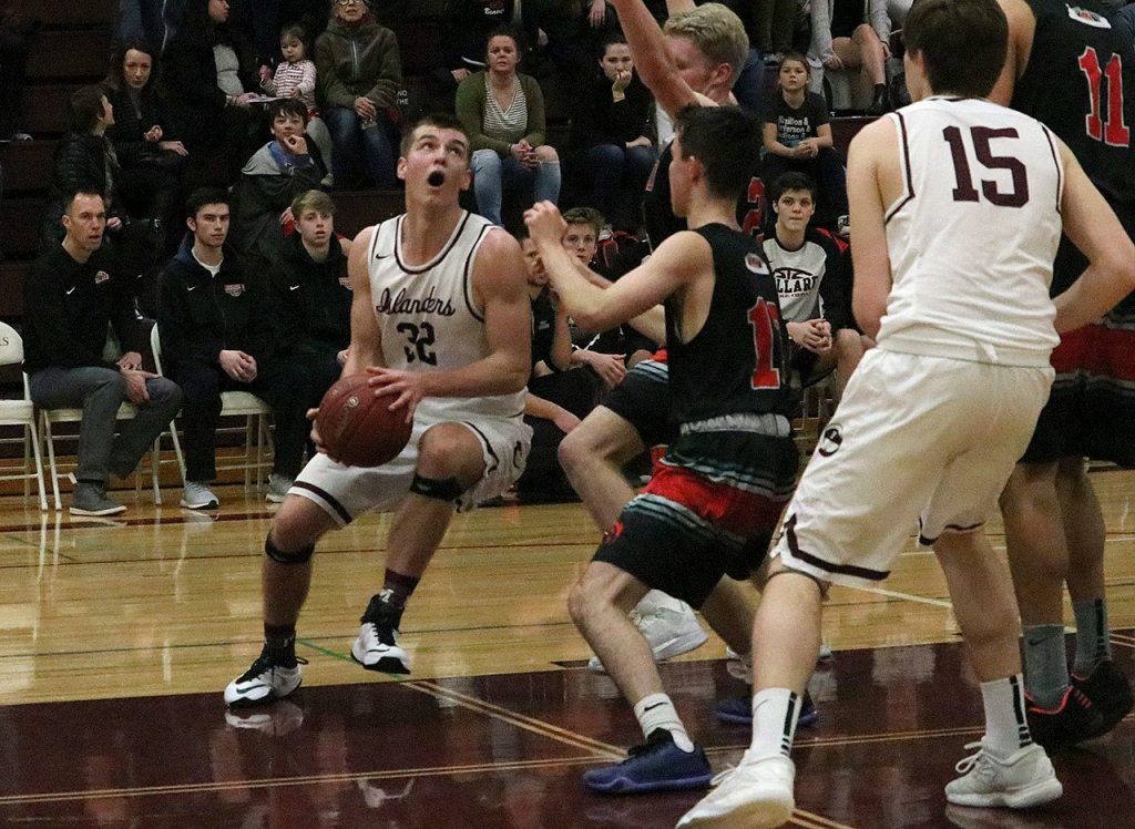 Mercer Island&rsquo;s Griffin Emanuels fights his way into the paint against Ballard on Feb. 11 at Mercer Island High School. Emanuels was recently named KingCo 2A/3A Defensive MVP (Joe Livarchik/staff photo).