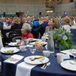 Longtime MIYFS supporter Myra Lupton (in red) listens to keynote speaker Dr. Kevin Haggerty. Haggerty was one of Lupton&rsquo;s students when she taught American literature at Sammamish High School. Katie Metzger/staff photo