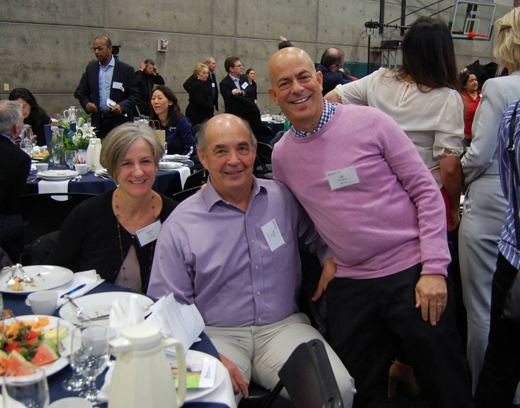 Former Island Books owners Nancy and Roger Page smile with Jeff Sanderson, former Stopsky&rsquo;s owner and current Mercer Island City Council member, at the MIYFS Foundation Breakfast. Katie Metzger/staff photo