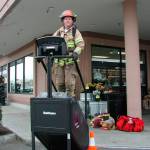 Mercer Island firefighter Trever Kissel climbs a Stairmaster in front of QFC as part of the department&rsquo;s fundraising efforts for the Scott Firefighter Stairclimb. Photo courtesy of MIFD