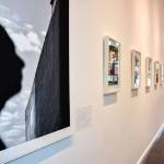 An art admirer looks at photos at SZ Art Gallery, which opened last March. Photo via www.suzannezahr.com