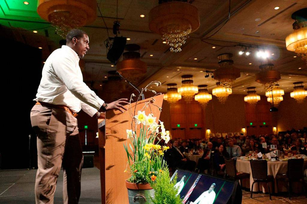Seattle Seahawks defensive end Tylor Harris encourages Celebration of Youth luncheon attendees to contribute financially to support Friends of Youth. Samantha Pak/Redmond Reporter